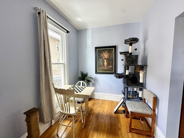 478 Barrett St, Elgin, IL 60120 - dining area featuring hardwood / wood-style floors, baseboards, and a wood stove