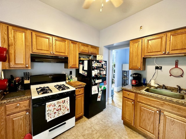 478 Barrett St, Elgin, IL 60120 - kitchen with gas range oven, a sink, freestanding refrigerator, under cabinet range hood, and brown cabinets