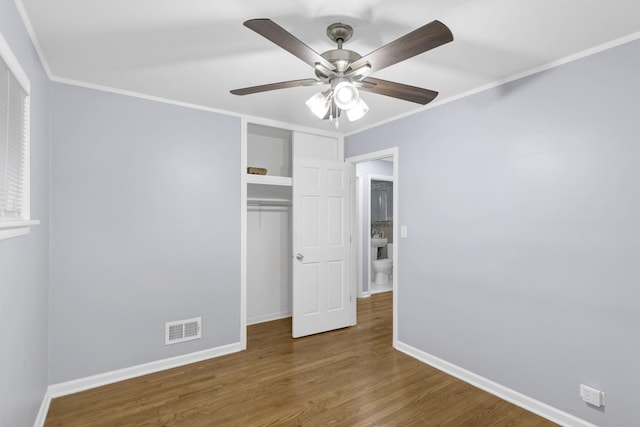1205 N Irving Ave, Berkeley, IL 60163 - unfurnished bedroom with baseboards, ornamental molding, wood finished floors, a closet, and a ceiling fan