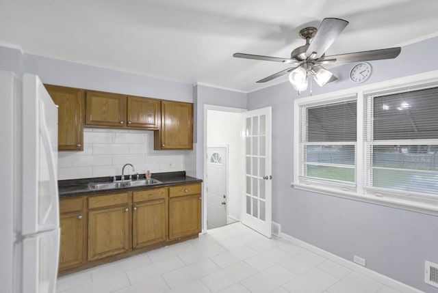 1205 N Irving Ave, Berkeley, IL 60163 - kitchen featuring a sink, freestanding refrigerator, brown cabinetry, and a ceiling fan