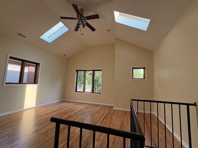 3037 W Polk Ave Unit 3, Chicago, IL 60612 - unfurnished room with a skylight, wood finished floors, ceiling fan, vaulted ceiling, and baseboards