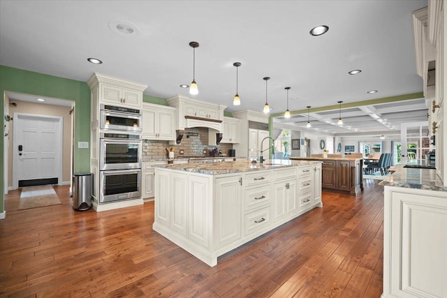1810 Cardinal Ct, Pontiac, IL 61764 - kitchen featuring a spacious island, coffered ceiling, recessed lighting, dark wood-style floors, and tasteful backsplash
