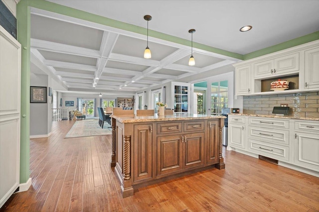 1810 Cardinal Ct, Pontiac, IL 61764 - kitchen featuring coffered ceiling, light wood finished floors, light stone countertops, white cabinetry, and hanging light fixtures