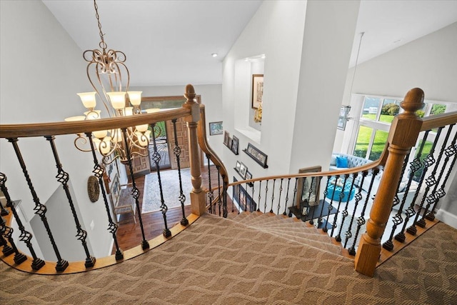 1810 Cardinal Ct, Pontiac, IL 61764 - stairs featuring a chandelier, vaulted ceiling, and carpet flooring