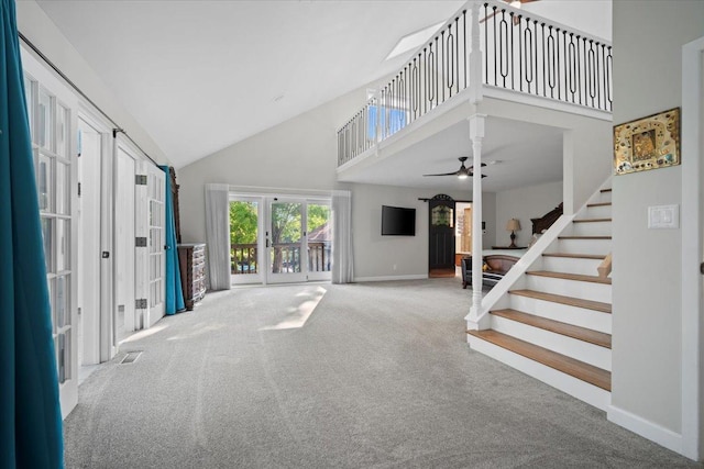 1810 Cardinal Ct, Pontiac, IL 61764 - unfurnished living room featuring carpet flooring, high vaulted ceiling, stairs, a ceiling fan, and french doors