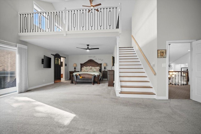 1810 Cardinal Ct, Pontiac, IL 61764 - stairs with ceiling fan, a towering ceiling, carpet, and a chandelier