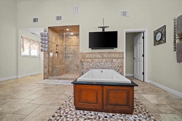1810 Cardinal Ct, Pontiac, IL 61764 - full bath featuring a towering ceiling, a garden tub, a stall shower, and stone tile flooring