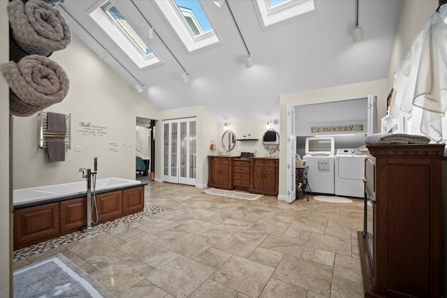 1810 Cardinal Ct, Pontiac, IL 61764 - full bath with washing machine and clothes dryer, a skylight, track lighting, a garden tub, and stone finish floors