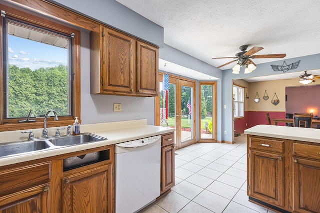 9650 Edgefield Rd, Roscoe, IL 61073 - kitchen with dishwasher, a ceiling fan, light countertops, brown cabinetry, and a textured ceiling