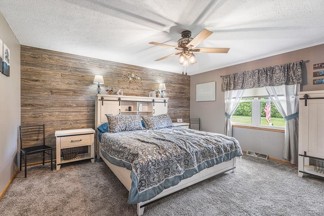 9650 Edgefield Rd, Roscoe, IL 61073 - bedroom featuring wooden walls, carpet flooring, a textured ceiling, and ceiling fan