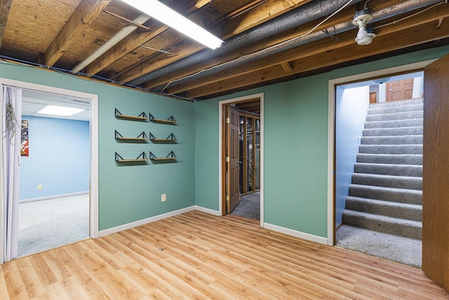9650 Edgefield Rd, Roscoe, IL 61073 - finished basement with stairway, baseboards, and wood finished floors