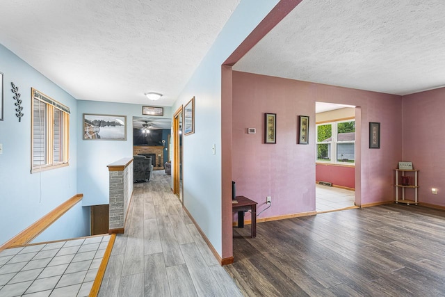 9650 Edgefield Rd, Roscoe, IL 61073 - hallway featuring a textured ceiling, wood finished floors, and baseboards