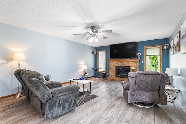 9650 Edgefield Rd, Roscoe, IL 61073 - living area featuring wood finished floors, ceiling fan, baseboards, and a fireplace