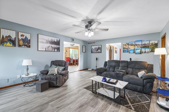 9650 Edgefield Rd, Roscoe, IL 61073 - living room featuring wood finished floors, baseboards, a textured ceiling, and a ceiling fan