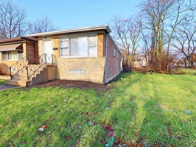 7056 S Honore St, Chicago, IL 60636 - view of front of property with brick siding and a front lawn