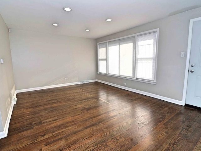 7056 S Honore St, Chicago, IL 60636 - unfurnished room featuring baseboards, dark wood-style floors, and recessed lighting