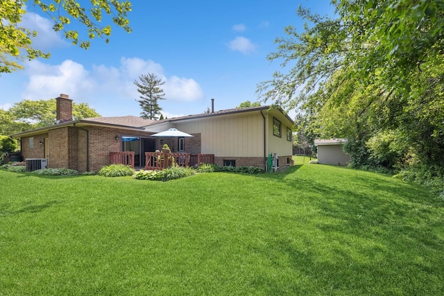 13040 W Tanglewood Cir, Palos Park, IL 60464 - back of property featuring a wooden deck, a chimney, brick siding, and a lawn