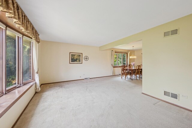 13040 W Tanglewood Cir, Palos Park, IL 60464 - carpeted spare room with a chandelier and baseboards