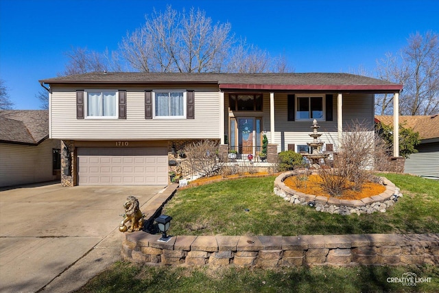 1710 Arlington Dr, Hanover Park, IL 60133 - raised ranch featuring an attached garage, driveway, a front yard, covered porch, and stone siding