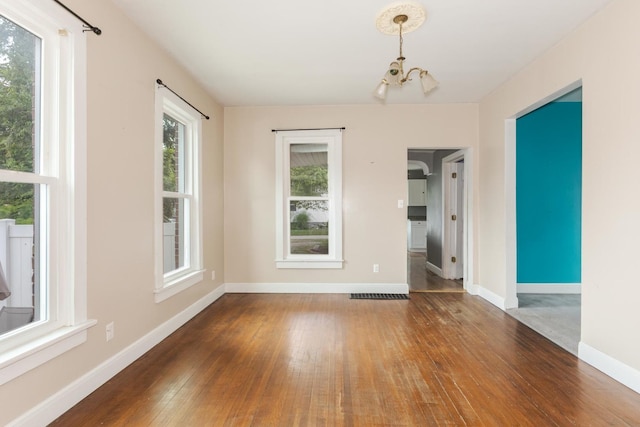 602 N Lee St, Bloomington, IL 61701 - unfurnished room with a chandelier and wood-type flooring