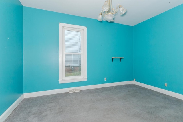 602 N Lee St, Bloomington, IL 61701 - spare room with a chandelier and carpet flooring