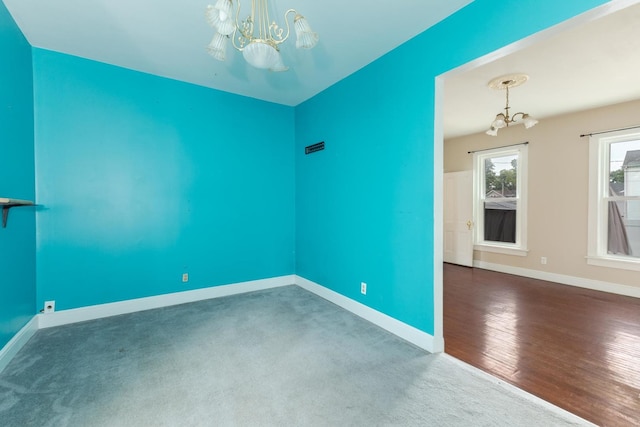 602 N Lee St, Bloomington, IL 61701 - carpeted spare room with a chandelier and wood finished floors