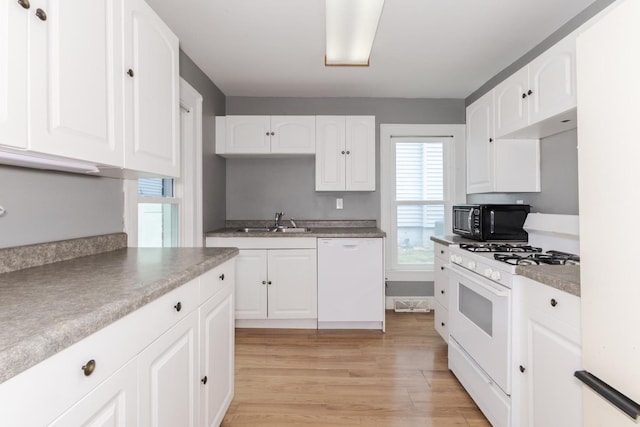 602 N Lee St, Bloomington, IL 61701 - kitchen with white appliances, light wood finished floors, plenty of natural light, and white cabinetry