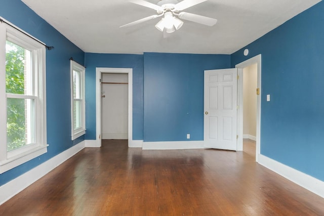 602 N Lee St, Bloomington, IL 61701 - unfurnished bedroom with dark wood-style flooring, a closet, and a ceiling fan