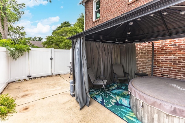 602 N Lee St, Bloomington, IL 61701 - view of patio / terrace featuring a gazebo, a gate, and a hot tub