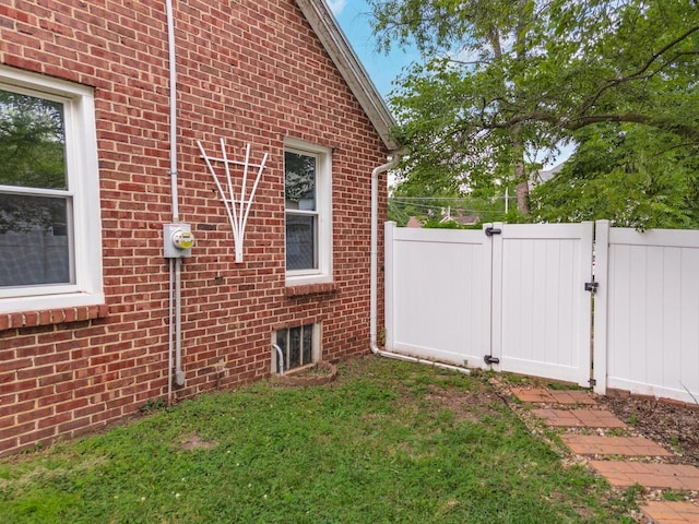 602 N Lee St, Bloomington, IL 61701 - view of property exterior with brick siding and a gate