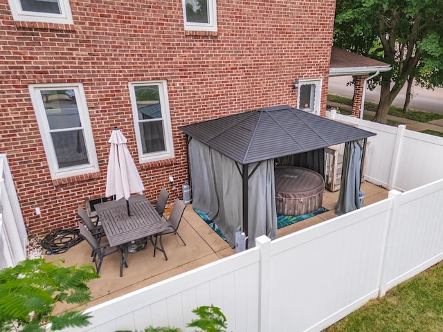 602 N Lee St, Bloomington, IL 61701 - wooden terrace with a covered hot tub, a fenced backyard, and a patio area