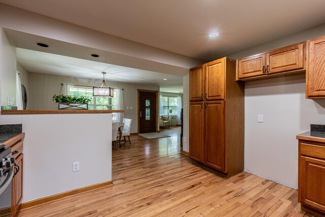 402 Lincoln St, Seatonville, IL 61359 - kitchen with stainless steel range, light wood-style floors, brown cabinets, recessed lighting, and dark countertops