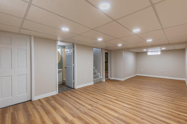 402 Lincoln St, Seatonville, IL 61359 - basement featuring light wood-style floors, stairway, a drop ceiling, and recessed lighting