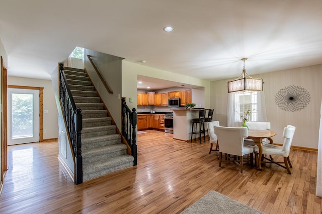 402 Lincoln St, Seatonville, IL 61359 - dining space with stairway, light wood-type flooring, a chandelier, and recessed lighting