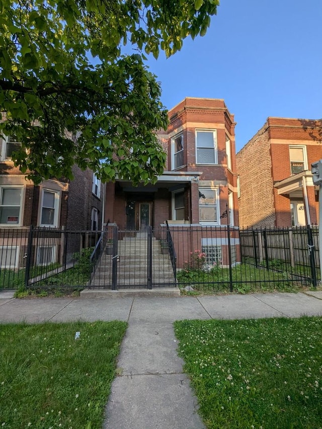 5527 S Winchester Ave, Chicago, IL 60636 - multi unit property featuring a fenced front yard, brick siding, and a gate