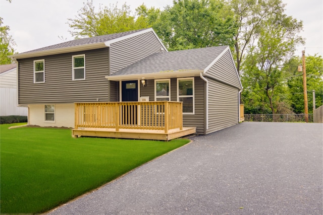 22156 Peach Tree Ave, Sauk Village, IL 60411 - split level home with a front lawn, roof with shingles, and a wooden deck