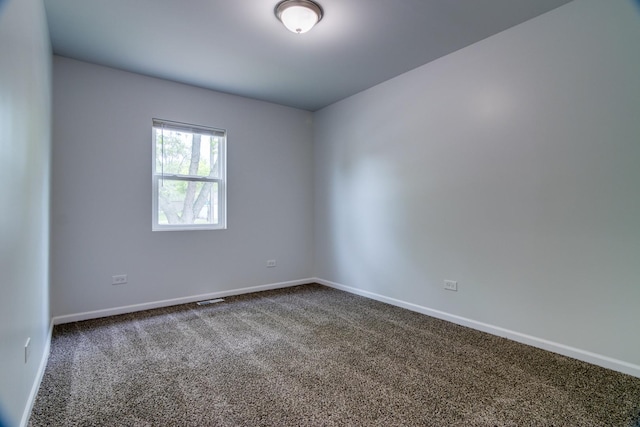 22156 Peach Tree Ave, Sauk Village, IL 60411 - empty room featuring dark colored carpet and baseboards