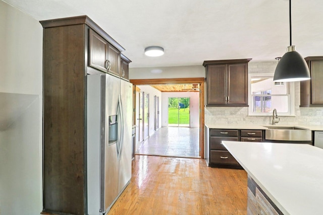 15807 W 139th St, Homer Glen, IL 60491 - kitchen featuring stainless steel fridge, dark brown cabinets, light countertops, light wood-style floors, and hanging light fixtures