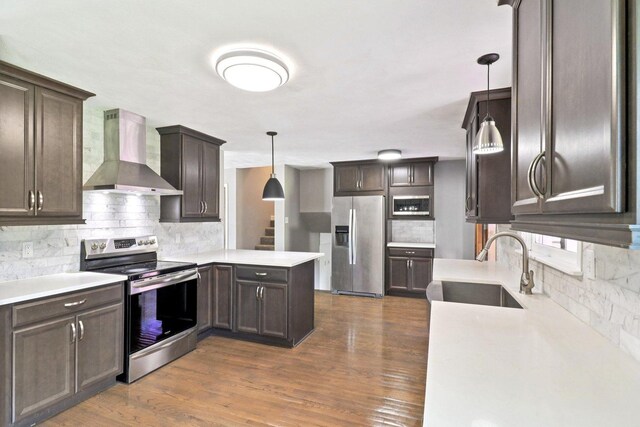 15807 W 139th St, Homer Glen, IL 60491 - kitchen with appliances with stainless steel finishes, wall chimney exhaust hood, decorative backsplash, a peninsula, and dark brown cabinetry
