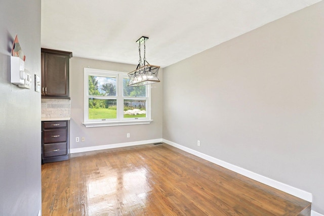 15807 W 139th St, Homer Glen, IL 60491 - unfurnished dining area featuring wood finished floors and baseboards