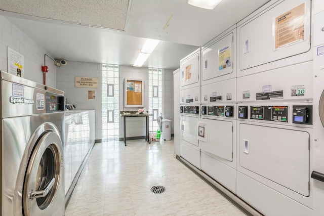 21 W Goethe St Unit 8K, Chicago, IL 60610 - shared laundry room featuring estacked washer and dryer, washer and clothes dryer, and concrete block wall