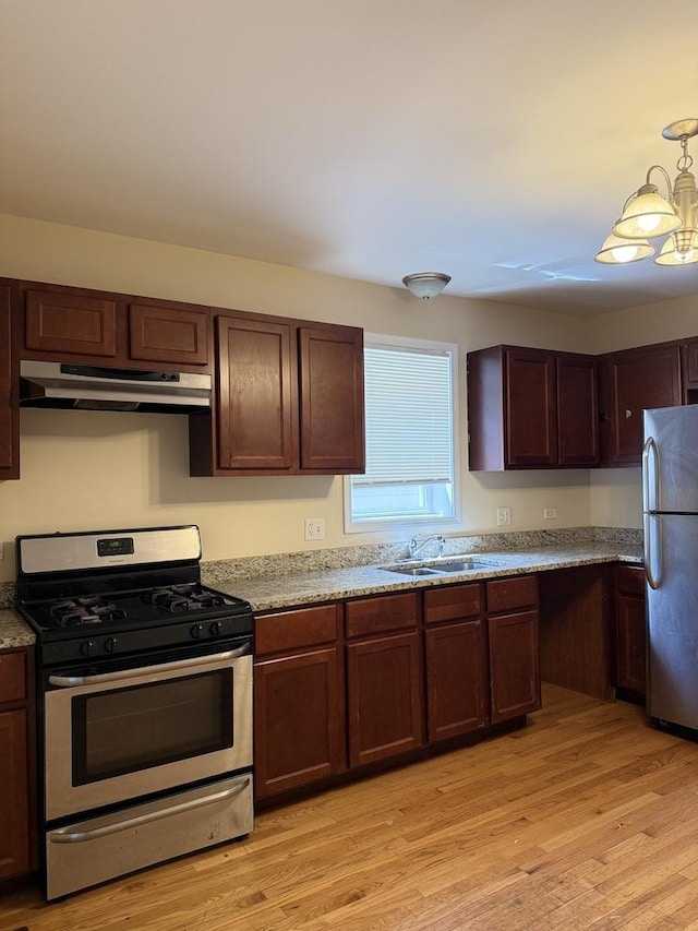 4637 S Honore St, Chicago, IL 60609 - kitchen with stainless steel appliances, under cabinet range hood, light wood-style flooring, and a sink