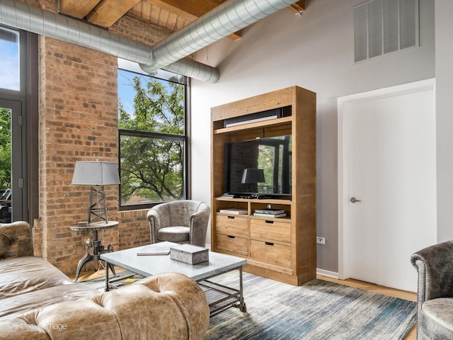 1040 W Adams St Unit 238, Chicago, IL 60607 - living area featuring plenty of natural light, wood finished floors, and a towering ceiling