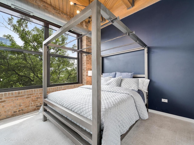 1040 W Adams St Unit 238, Chicago, IL 60607 - carpeted bedroom with baseboards and brick wall