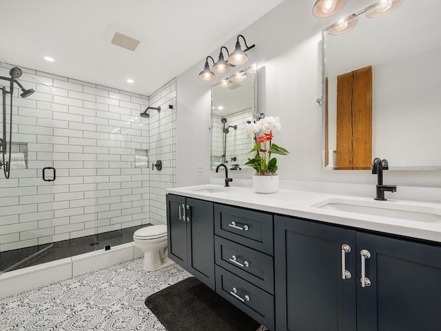 1040 W Adams St Unit 238, Chicago, IL 60607 - full bathroom featuring a stall shower, double vanity, toilet, tile patterned flooring, and recessed lighting