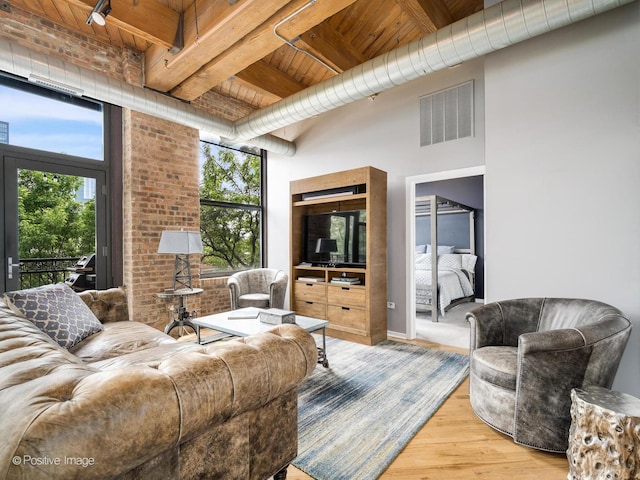 1040 W Adams St Unit 238, Chicago, IL 60607 - living area featuring wood ceiling with exposed beams, plenty of natural light, and wood finished floors