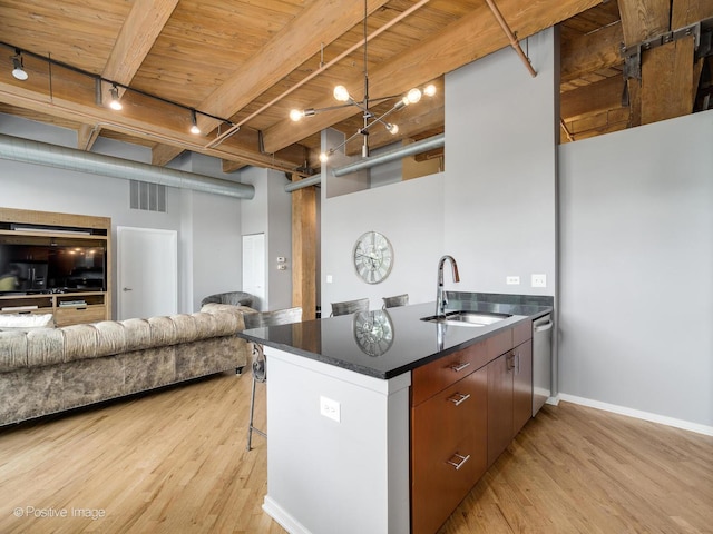 1040 W Adams St Unit 238, Chicago, IL 60607 - kitchen with a sink, light wood-style flooring, dark countertops, open floor plan, and wood ceiling with exposed beams