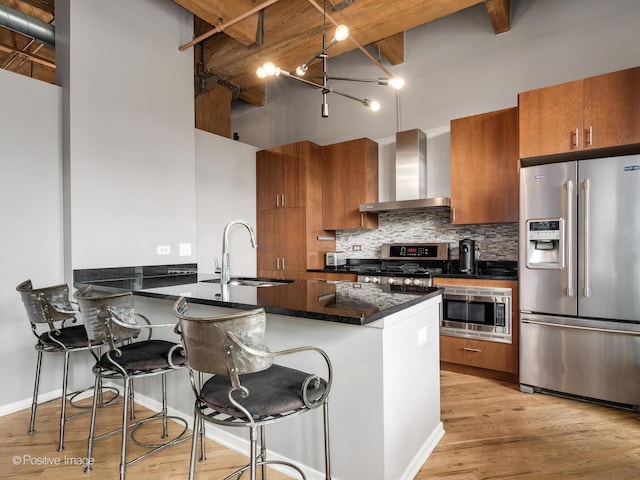 1040 W Adams St Unit 238, Chicago, IL 60607 - kitchen with appliances with stainless steel finishes, wall chimney exhaust hood, a sink, brown cabinetry, and a high ceiling