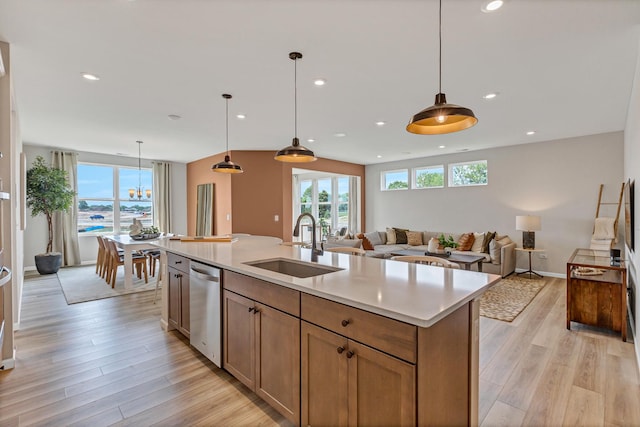 2804 Autumn Ridge Ct, Lindenhurst, IL 60046 - kitchen with a sink, stainless steel dishwasher, light wood finished floors, light countertops, and open floor plan