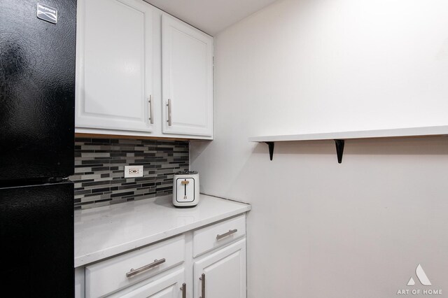 9146 W 140th St Unit 2Sw, Orland Park, IL 60462 - kitchen with freestanding refrigerator, backsplash, white cabinets, and light countertops